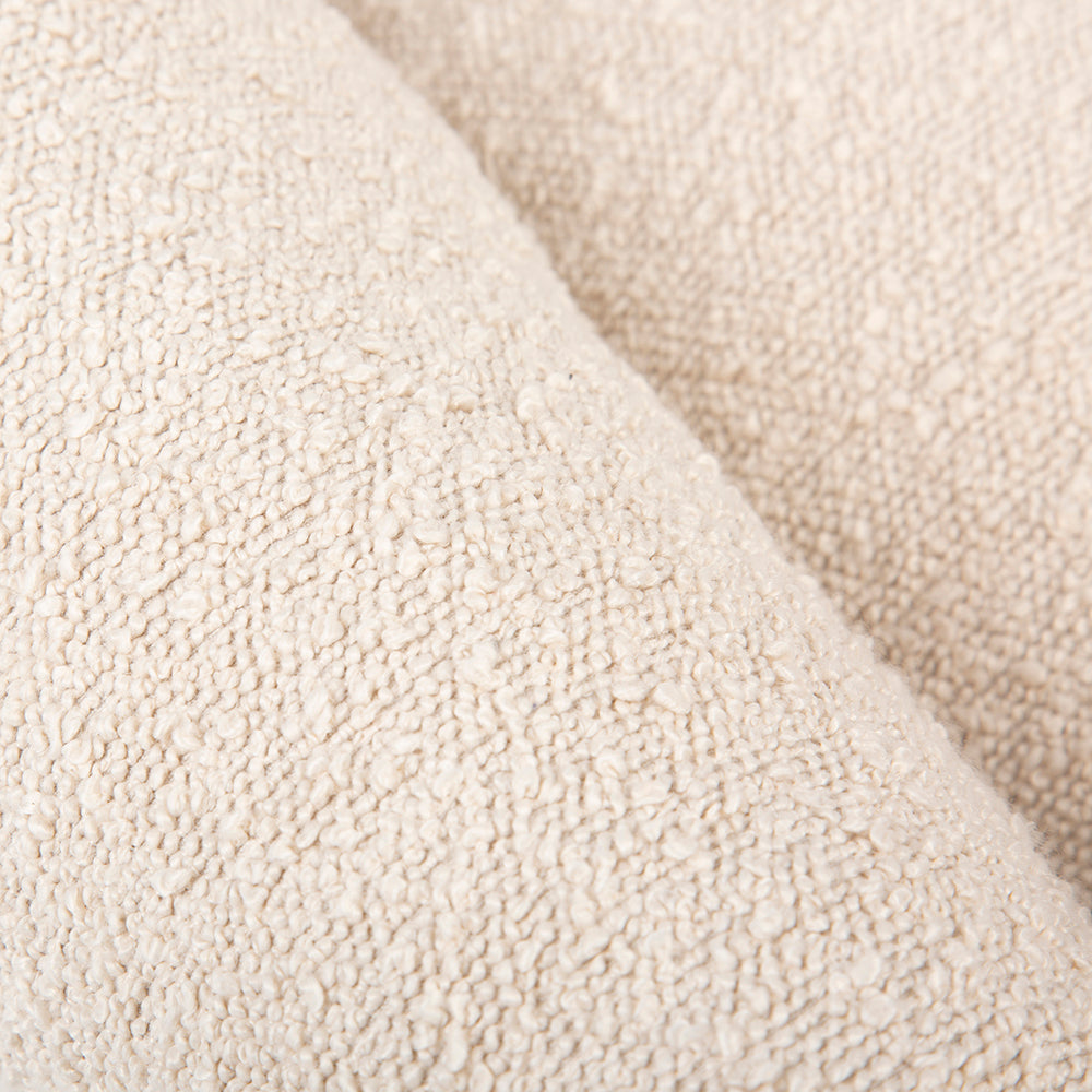Close-up of ivory textured fabric on a dog bed