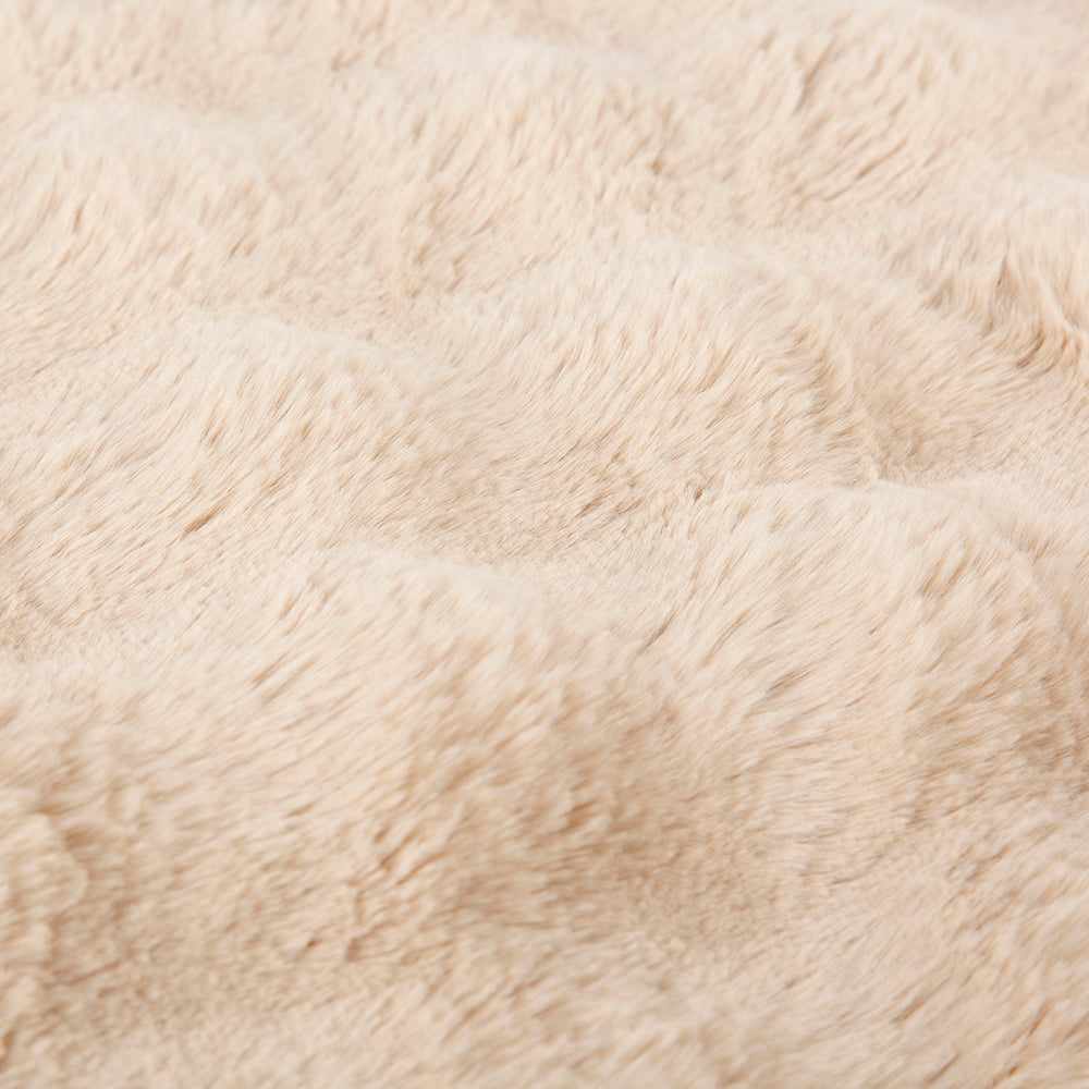 Close-up of dog mattress showing beige fur texture