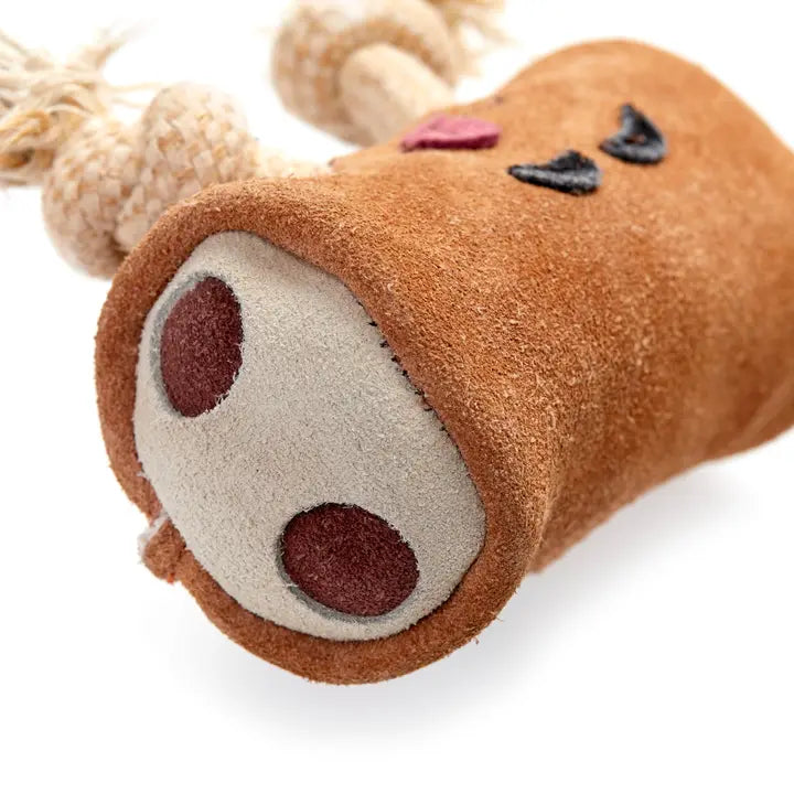 Eco dog toy resembling a log with a face on a white background
