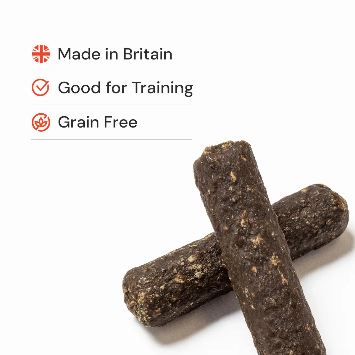 Two dark brown natural dog treats on a white background with text indicating 'Made in Britain', 'Good for Training', and 'Grain Free'.