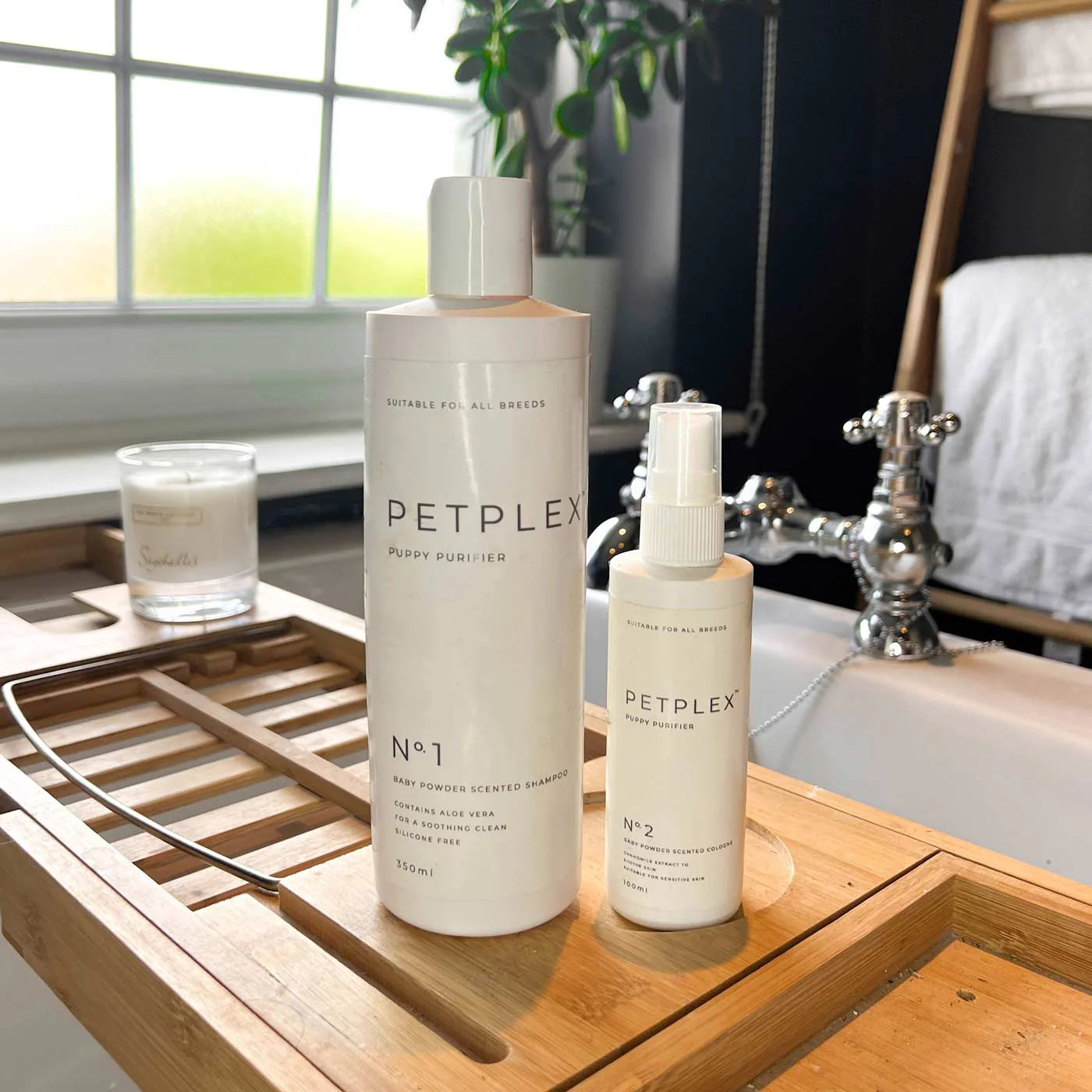 Two Petplex puppy shampoo and cologne set on a wooden surface with a bathroom background.