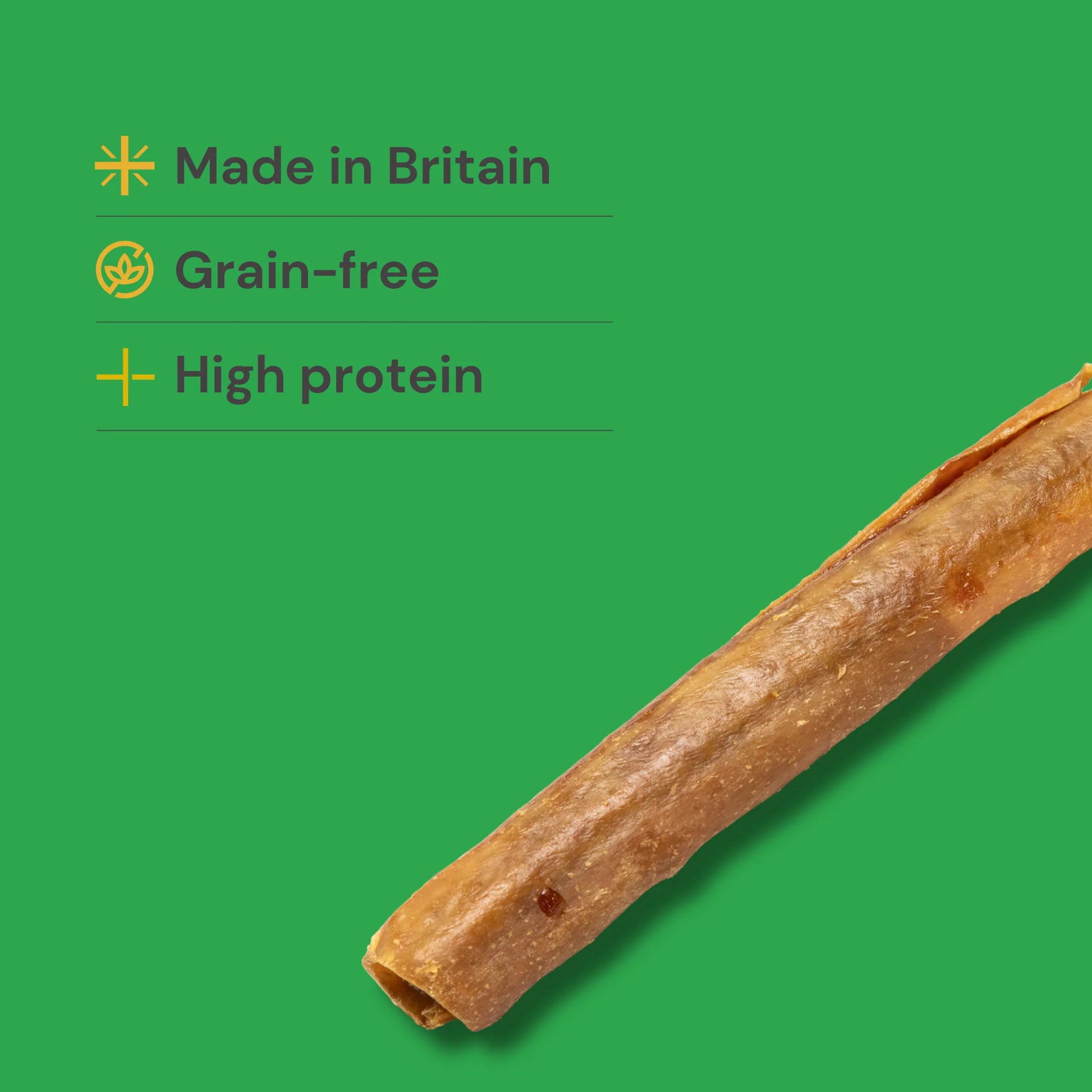 Sausage roll natural dog treats on a green background with text indicating 'Made in Britain', 'Grain-free', and 'High protein'.