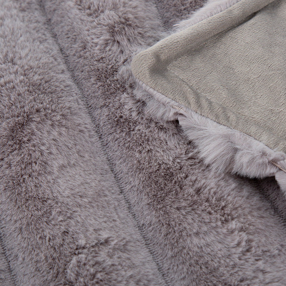 Close-up of grey faux fur blanket fabric texture.