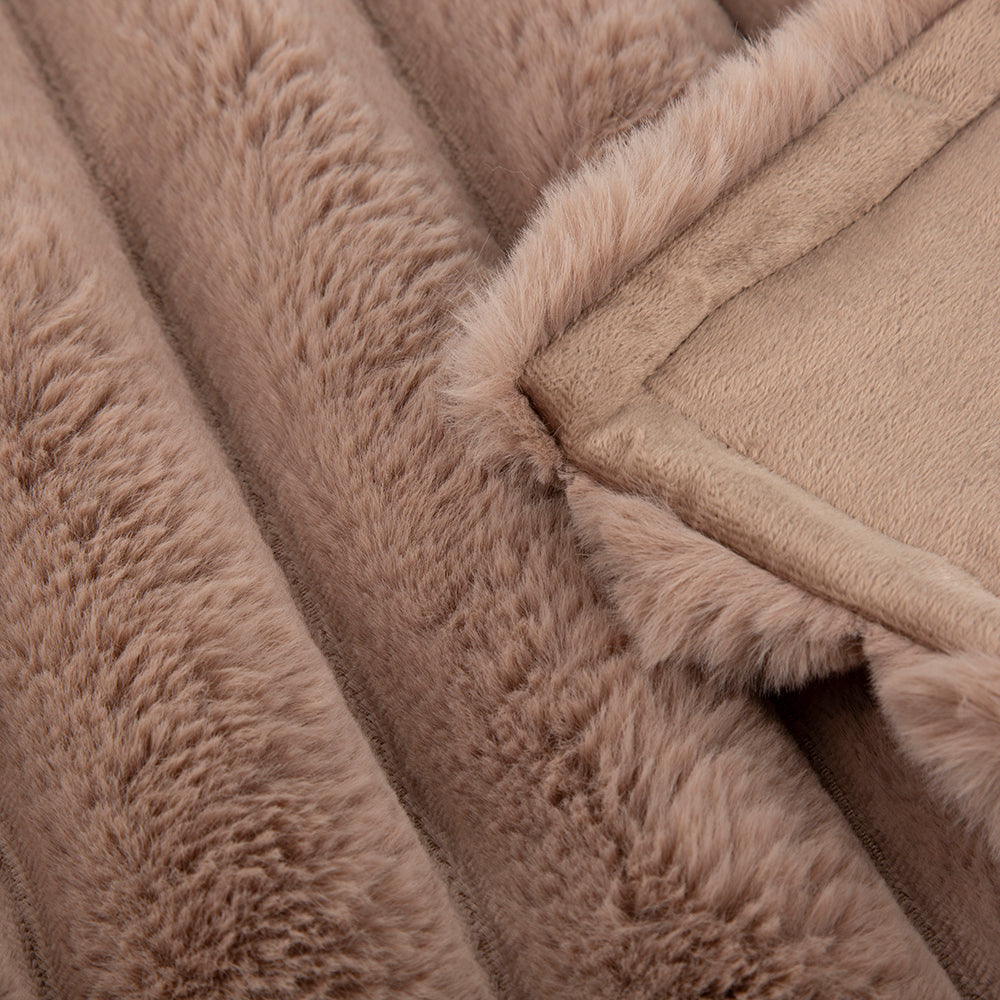 Close-up of taupe faux fur blanket fabric texture.