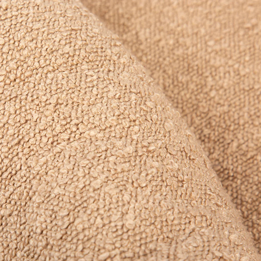 Close up of desert brown boucle fabric texture on box dog bed