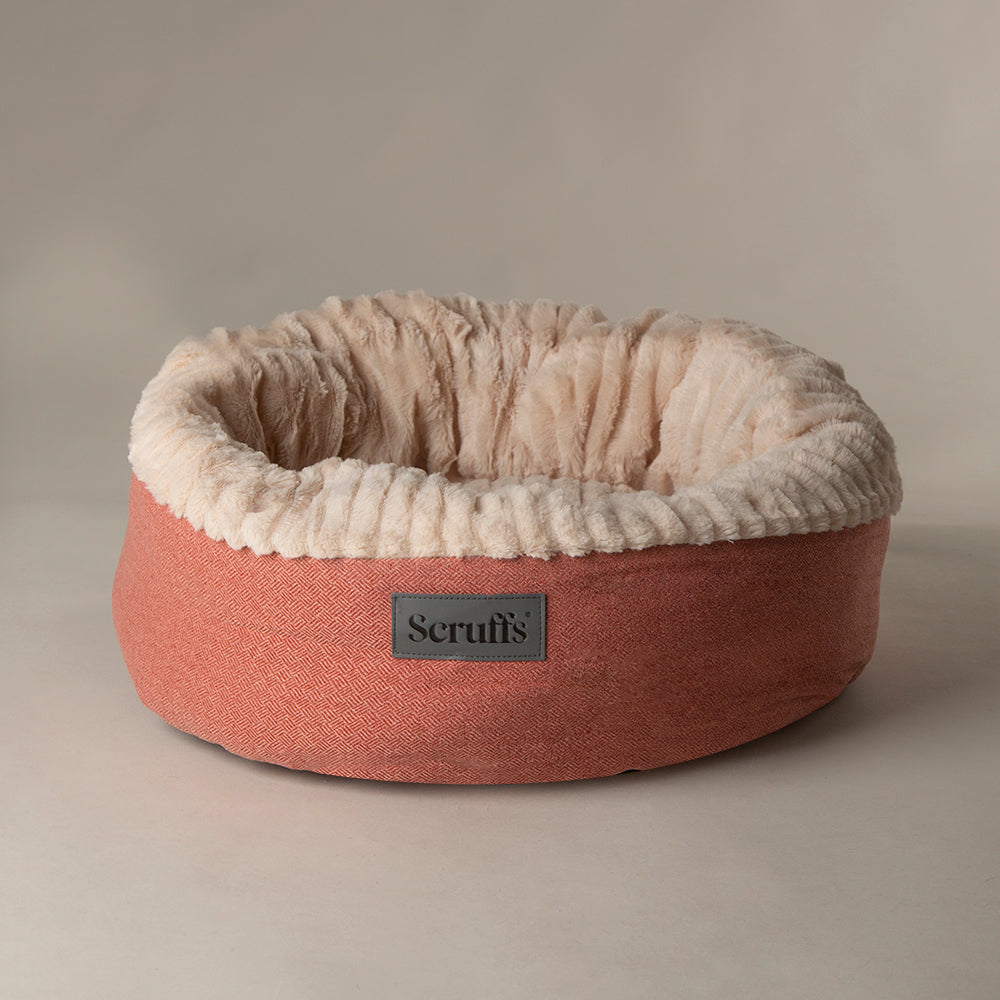 Scruffs Ellen donut dog bed in terracotta red on a plain background.