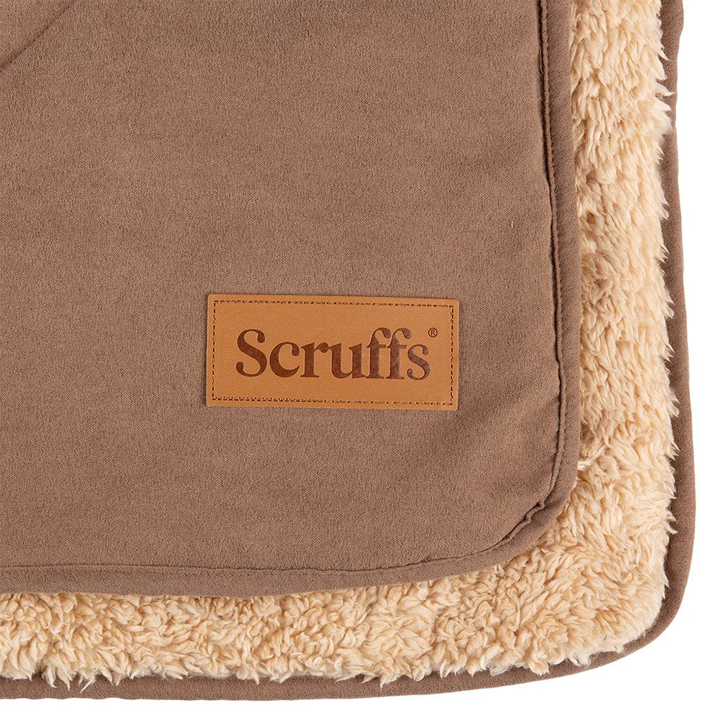 Close-up of Scruffs snuggle blanket in caramel brown showing logo detail