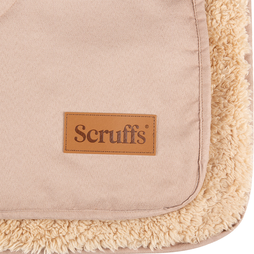 Close-up of Scruffs snuggle blanket in desert sand showing logo detail