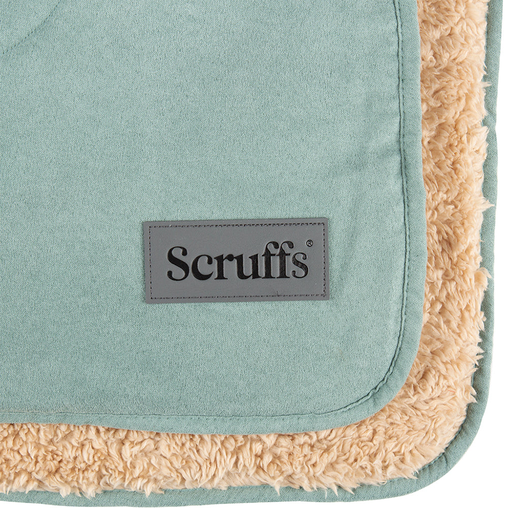 Close-up of Scruffs snuggle blanket in sage green showing logo detail